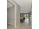 Inviting hallway that opens to a stylish living area with a view of the pool at 6252 Winding Pine Dr, Nokomis, FL 34275