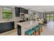 Modern kitchen with stainless steel appliances, granite countertops and a stylish island at 6252 Winding Pine Dr, Nokomis, FL 34275