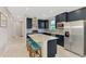 Well-designed kitchen features an island with seating, stainless appliances, and ample cabinet space at 6252 Winding Pine Dr, Nokomis, FL 34275