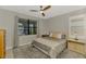 Cozy main bedroom featuring a large window with pool views and a ceiling fan at 6252 Winding Pine Dr, Nokomis, FL 34275