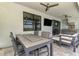Outdoor dining area with a table, seating, and adjacent kitchen offers a perfect space for gatherings at 6252 Winding Pine Dr, Nokomis, FL 34275