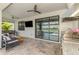 Spacious covered patio with an outdoor kitchen, comfortable seating, and serene pool views at 6252 Winding Pine Dr, Nokomis, FL 34275