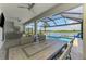 Covered patio with an outdoor dining area, kitchen, and seating showcases outdoor living at its finest at 6252 Winding Pine Dr, Nokomis, FL 34275
