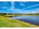 Scenic view of the backyard pond in a well-manicured backyard. The pond adds natural beauty at 6252 Winding Pine Dr, Nokomis, FL 34275