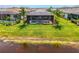 Beautiful screened-in pool area featuring a serene view of the adjacent lake at 6252 Winding Pine Dr, Nokomis, FL 34275