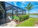 Screened pool enclosure with patio and view of the lake provides a private outdoor oasis at 6252 Winding Pine Dr, Nokomis, FL 34275