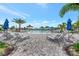 Beautiful community pool with lounge chairs and palm trees for a relaxing poolside experience at 6252 Winding Pine Dr, Nokomis, FL 34275