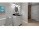 Bathroom with modern vanity, framed mirror, and tiled shower; well-lit and functional at 6422 Beechwood Ave, Sarasota, FL 34231