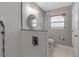 Modern bathroom featuring sleek fixtures, glass shower partition, and a minimalist design at 6422 Beechwood Ave, Sarasota, FL 34231