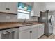 Bright kitchen featuring granite countertops, stainless steel appliances, and white cabinets at 6422 Beechwood Ave, Sarasota, FL 34231