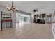 Bright living room with tile floors, fireplace, and access to sunroom; great flow for entertaining at 6422 Beechwood Ave, Sarasota, FL 34231