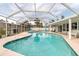 Covered pool offers a refreshing retreat with spacious poolside seating and a view of palm trees at 6422 Beechwood Ave, Sarasota, FL 34231