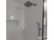 Bright shower with white subway tile, rainfall head, handheld sprayer, and a built-in niche for storage at 6422 Beechwood Ave, Sarasota, FL 34231