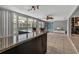 Sunroom featuring tile floors, wet bar and is seamlessly connected to the living room and pool at 6422 Beechwood Ave, Sarasota, FL 34231