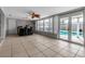 Sunroom featuring a wet bar, tile floors and direct access to the pool; indoor-outdoor living at 6422 Beechwood Ave, Sarasota, FL 34231