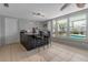 Sunroom features tile floors, wet bar with seating, bright windows offering views of the pool at 6422 Beechwood Ave, Sarasota, FL 34231