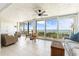 Charming balcony with dining set and lounge chair offering stunning ocean views and ample sunlight at 6460 Mourning Dove Dr # 102, Bradenton, FL 34210