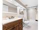 Bathroom with wood vanity, framed mirror, and a shower-tub combination with tiled walls at 6460 Mourning Dove Dr # 102, Bradenton, FL 34210