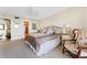 Spacious bedroom featuring a queen bed, ceiling fan, and ensuite bathroom for added convenience at 6460 Mourning Dove Dr # 102, Bradenton, FL 34210