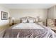 Comfortable bedroom with a queen bed, neutral walls, and accent pillows for a relaxing retreat at 6460 Mourning Dove Dr # 102, Bradenton, FL 34210