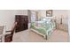 Cozy bedroom with a decorative bed frame, dresser, and neutral-toned walls and carpet at 6460 Mourning Dove Dr # 102, Bradenton, FL 34210