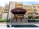 Inviting condo entrance with elegant awning, landscaped surroundings, and convenient access at 6460 Mourning Dove Dr # 102, Bradenton, FL 34210