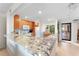 Open-concept kitchen with granite countertop bar and modern appliances at 6460 Mourning Dove Dr # 102, Bradenton, FL 34210