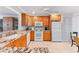 Bright kitchen with granite countertops, wooden cabinets, and modern appliances at 6460 Mourning Dove Dr # 102, Bradenton, FL 34210