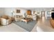 Inviting living room with plush seating, a large area rug, and a view into the dining area at 6460 Mourning Dove Dr # 102, Bradenton, FL 34210