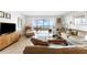 Spacious living room featuring tile flooring, neutral decor, and a sliding glass door to the balcony at 6460 Mourning Dove Dr # 102, Bradenton, FL 34210