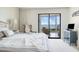 Serene main bedroom with neutral tones, balcony access, and picturesque views of the ocean at 6460 Mourning Dove Dr # 102, Bradenton, FL 34210