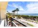 Serene waterfront view from the condo's balcony, featuring lush trees and beautiful sky at 6460 Mourning Dove Dr # 102, Bradenton, FL 34210