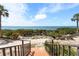 Breathtaking water view from the condo's stairs, surrounded by lush tropical greenery at 6460 Mourning Dove Dr # 102, Bradenton, FL 34210