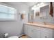Bright bathroom with double sinks, white cabinetry, and great lighting at 649 Fairmount Dr, North Port, FL 34287