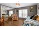 Comfortable bedroom features a mirrored wall, wood flooring, and natural lighting at 649 Fairmount Dr, North Port, FL 34287