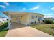Charming single-story home with a covered carport and a well-maintained lawn at 649 Fairmount Dr, North Port, FL 34287