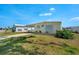 Exterior view of the house showing the front lawn and awning carport at 649 Fairmount Dr, North Port, FL 34287