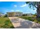 Charming single-story home with well-maintained lawn, driveway and mature shade tree at 649 Fairmount Dr, North Port, FL 34287