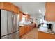 The bright kitchen shows stainless steel appliances, wood cabinets, laminate countertops and an eat-in dining area at 649 Fairmount Dr, North Port, FL 34287