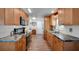 Functional kitchen design with light wood cabinets, stainless steel appliances, and solid countertops at 649 Fairmount Dr, North Port, FL 34287