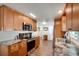 Well-lit kitchen features wood cabinets, stainless steel appliances, and laminate countertops and flooring at 649 Fairmount Dr, North Port, FL 34287