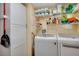 Laundry room with front loading washer and dryer and shelving for supplies at 649 Fairmount Dr, North Port, FL 34287