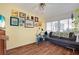 Living room with wood floors, a sofa, exercise bike, and many framed artworks at 649 Fairmount Dr, North Port, FL 34287