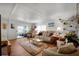 Bright living room with comfortable seating and sliding glass doors leading to a screened-in lanai at 649 Fairmount Dr, North Port, FL 34287