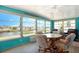Comfortable sunroom with plenty of natural light and views of the canal at 649 Fairmount Dr, North Port, FL 34287