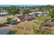 Bird's-eye view of property showing fenced-in yard with a firepit, a screened porch, and mature trees at 6547 Samoa Dr, Sarasota, FL 34241