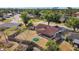 Aerial view of backyard with screened-in porch, fenced yard, and green fire pit at 6547 Samoa Dr, Sarasota, FL 34241