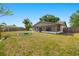 Large backyard with a screened-in lanai, fire pit, and secure fencing at 6547 Samoa Dr, Sarasota, FL 34241