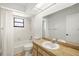 Bright bathroom with a tub, shower, and a single-sink vanity with wood cabinets at 6547 Samoa Dr, Sarasota, FL 34241
