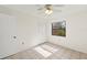 Simple bedroom with ceramic tile floors, ceiling fan and a window overlooking backyard at 6547 Samoa Dr, Sarasota, FL 34241